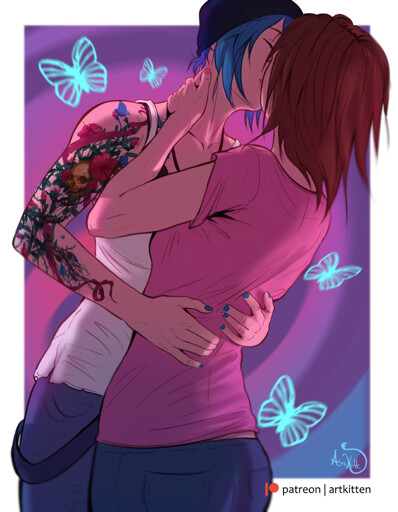 Two women embracing, kissing each other. One is wearing a beanie, has blue hair, a tattoo that covers her arm, is wearing a white tanktop and blue pants, her nails also painted blue. The other has brown hair, is wearing a pink shirt and bluejeans. There are drawings of blue butterflies around them. 
